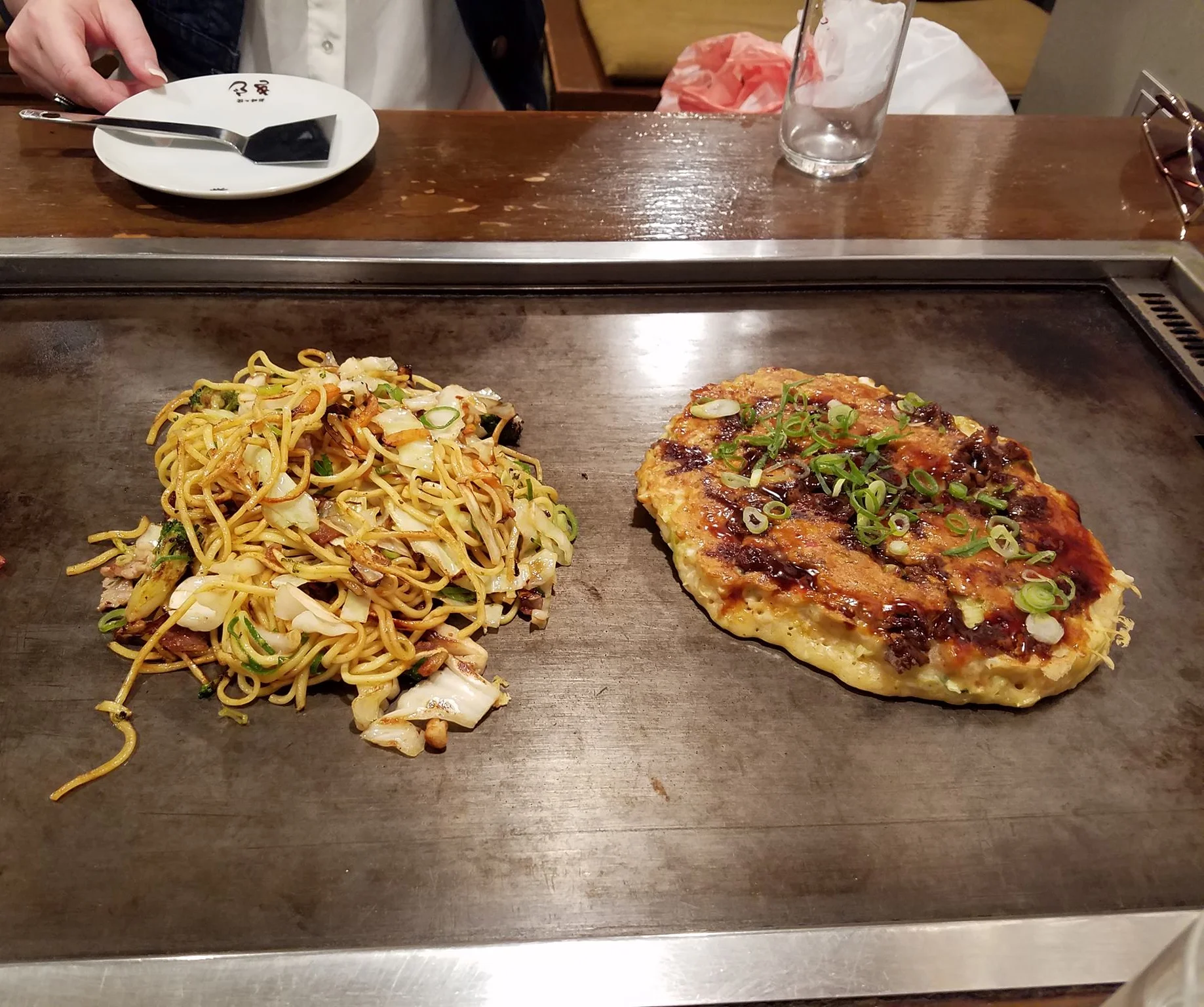 Japanese okonomiyaki and yakisoba on a teppanyaki grill