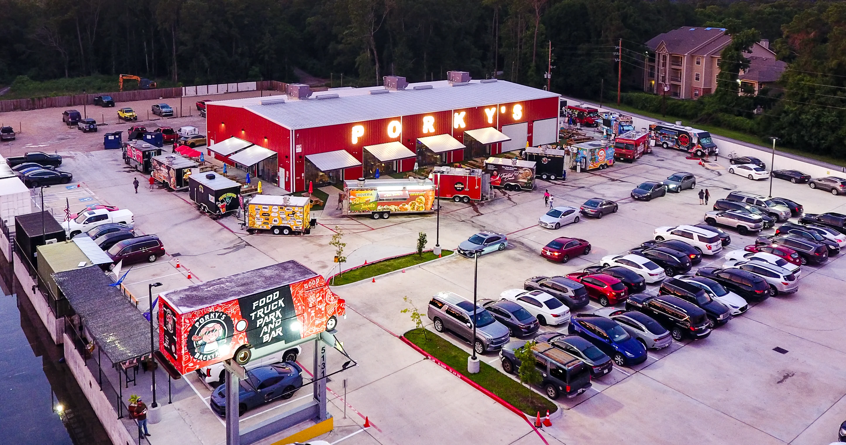 Food truck park with vibrant sunset and bustling atmosphere