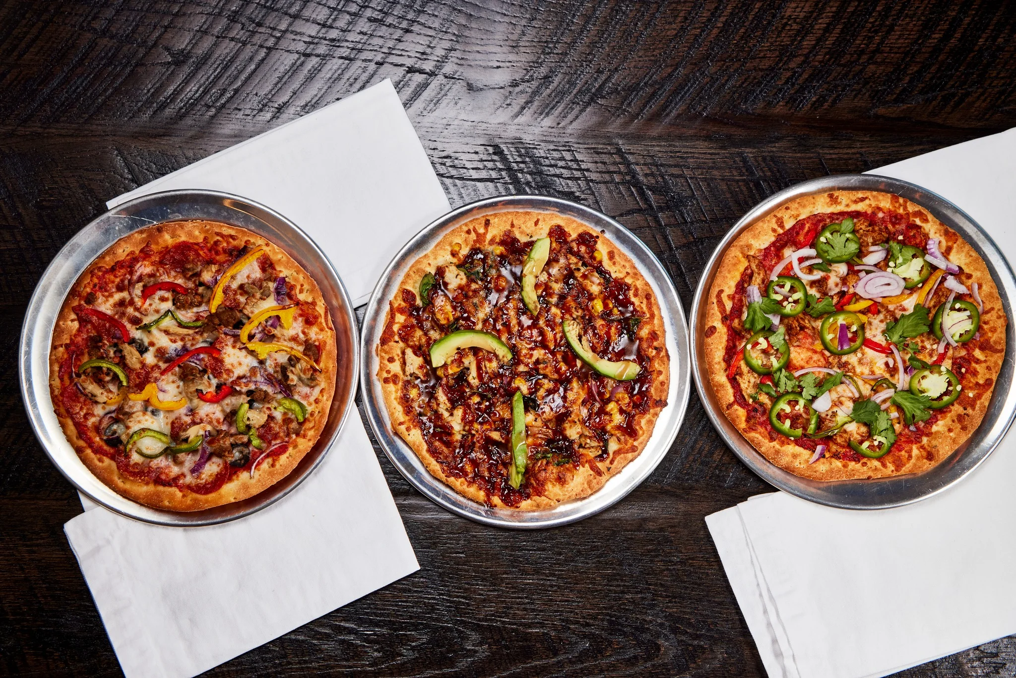 Three delicious pizzas featuring various toppings