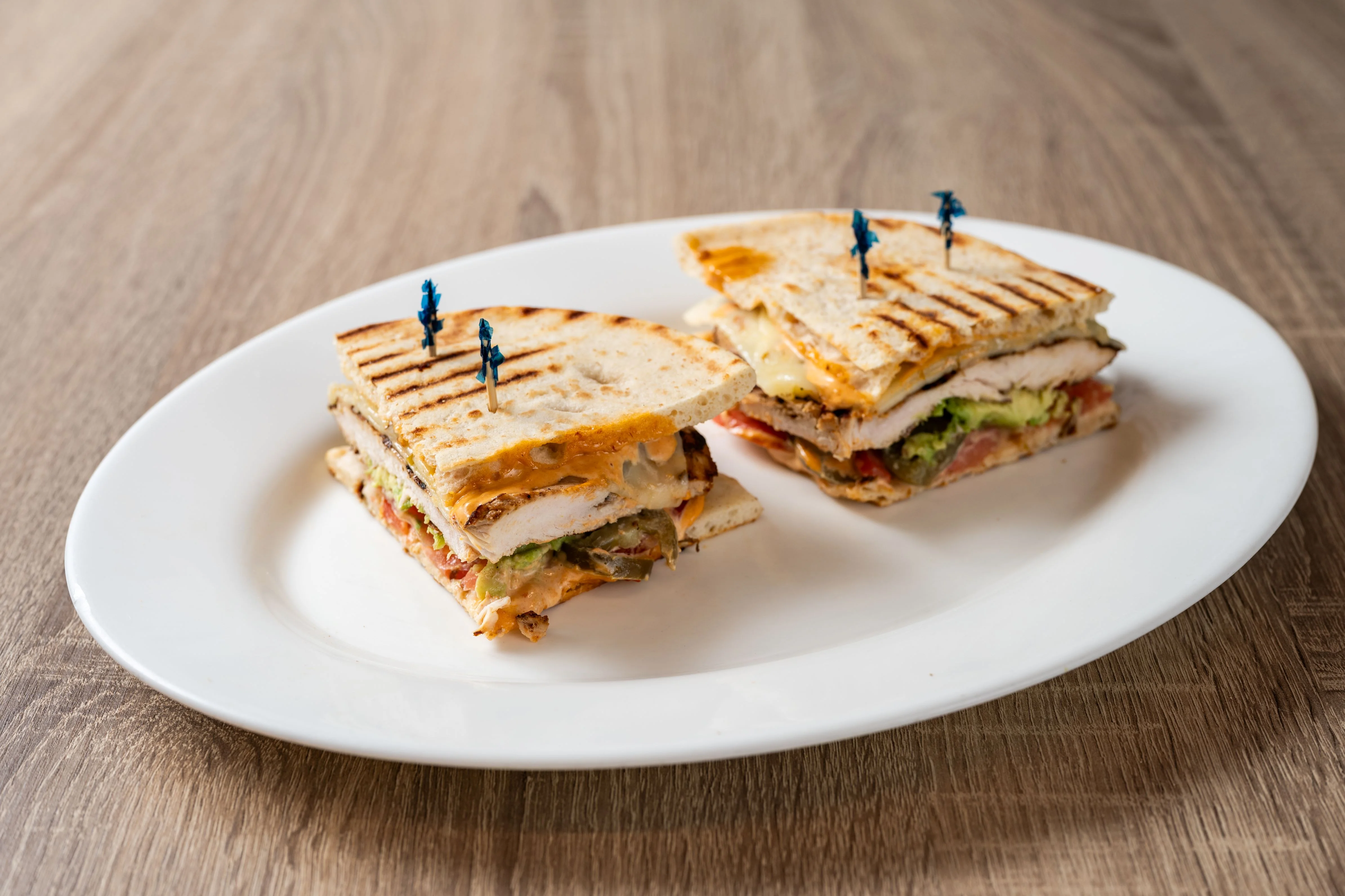 Delicious deli sandwich with fresh ingredients on a wooden table