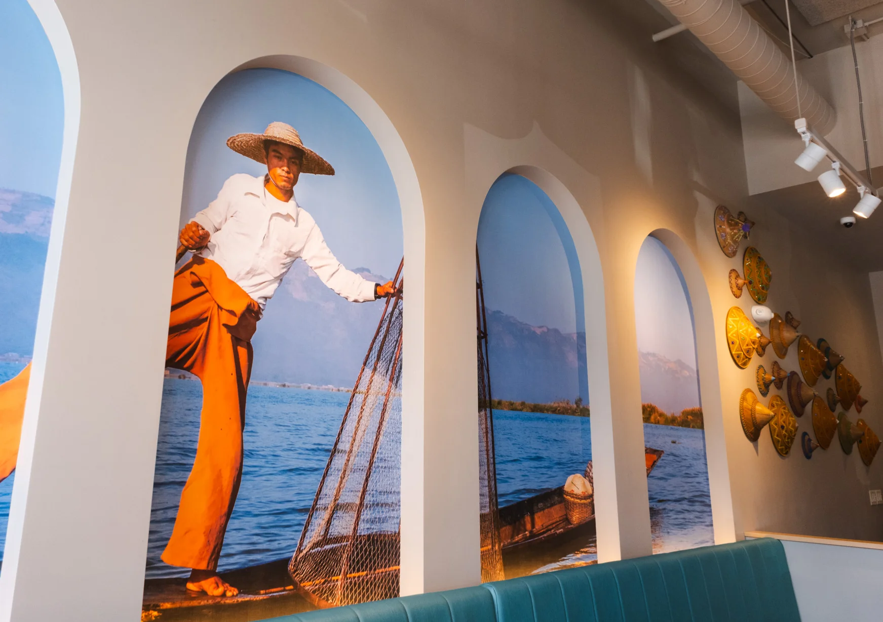 Vibrant restaurant mural depicting a fisherman on a lake