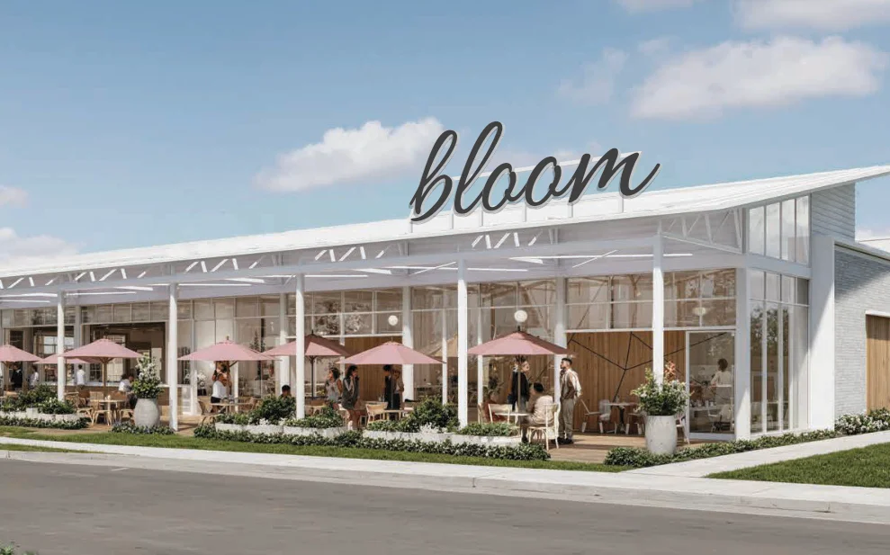 Modern restaurant exterior with outdoor seating and pink umbrellas