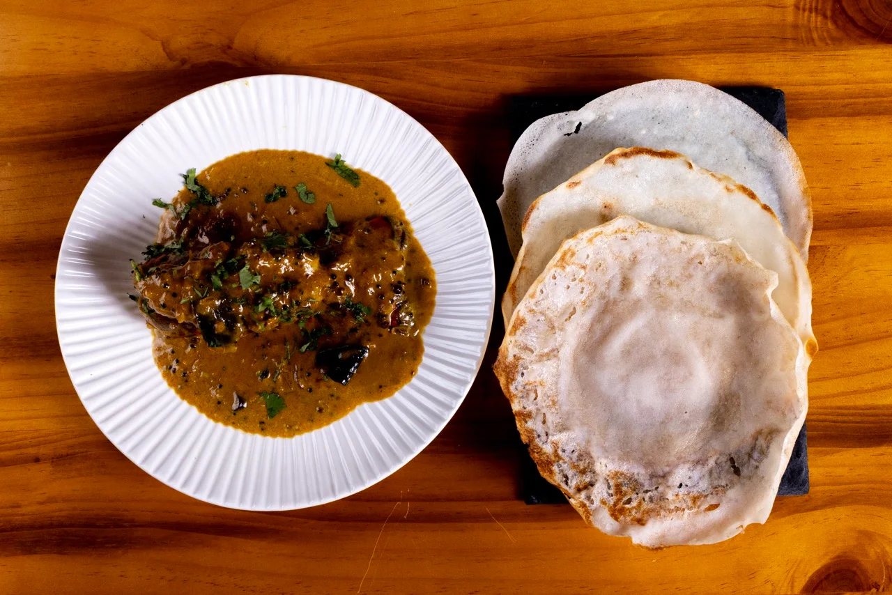 South Indian curry with dosa on a wooden table