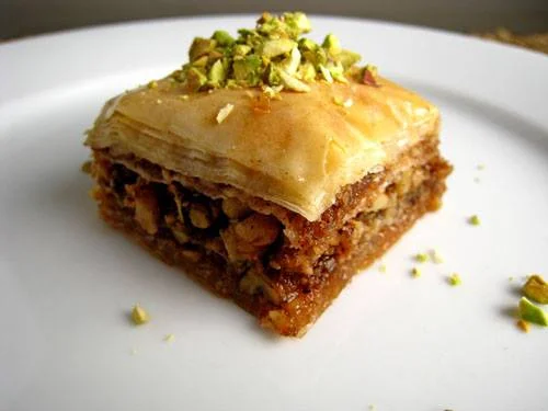 Delicious piece of Middle Eastern baklava topped with crushed pistachios