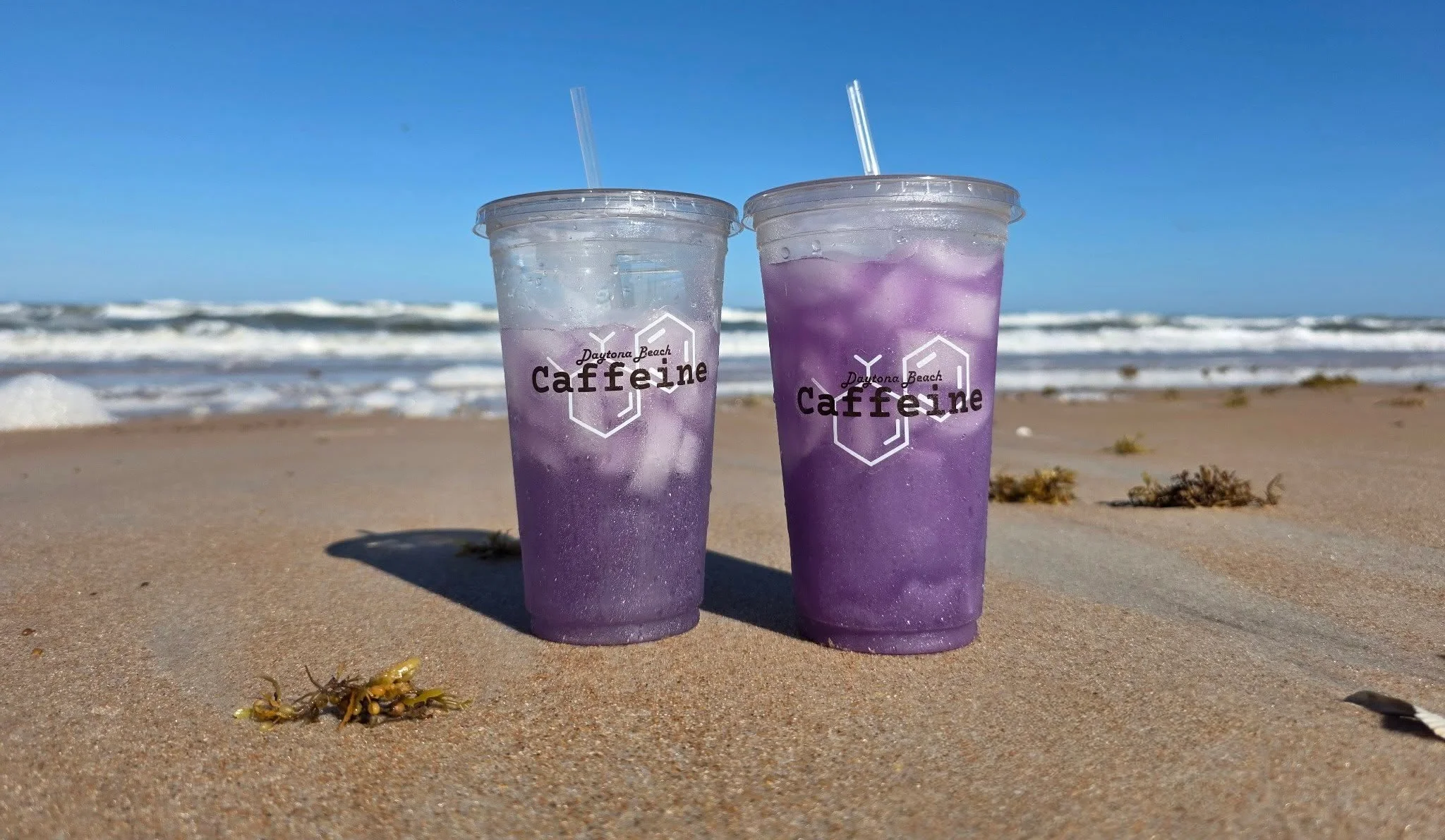 Refreshing purple iced drinks on a beach