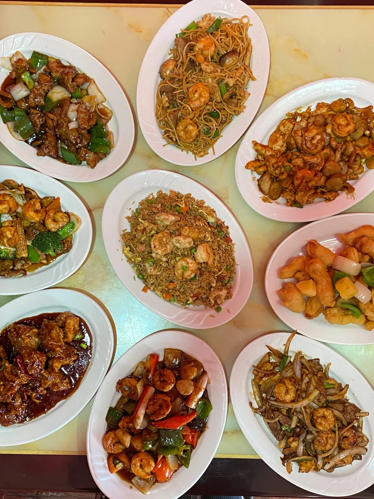Assorted Chinese dishes including fried rice and shrimp stir-fry