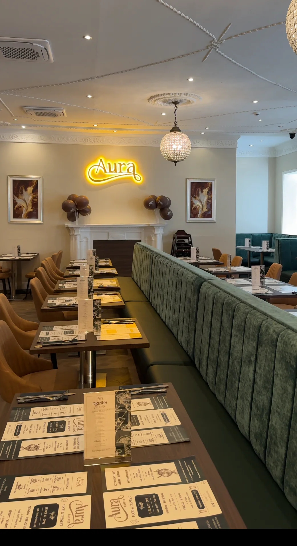Interior of Aura restaurant with seating and decorative lighting.