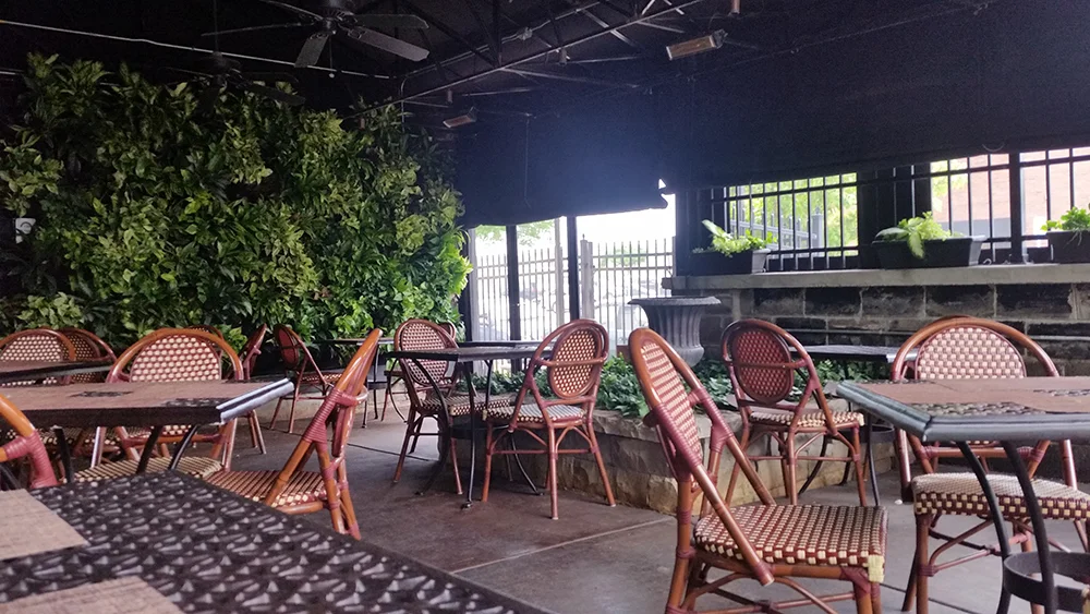 Charming outdoor dining area with greenery and cozy seating