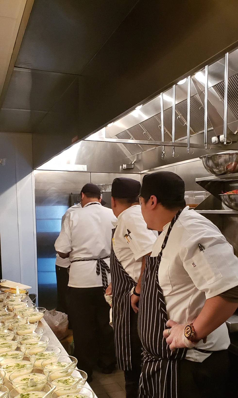 Chefs preparing dishes in a busy restaurant kitchen