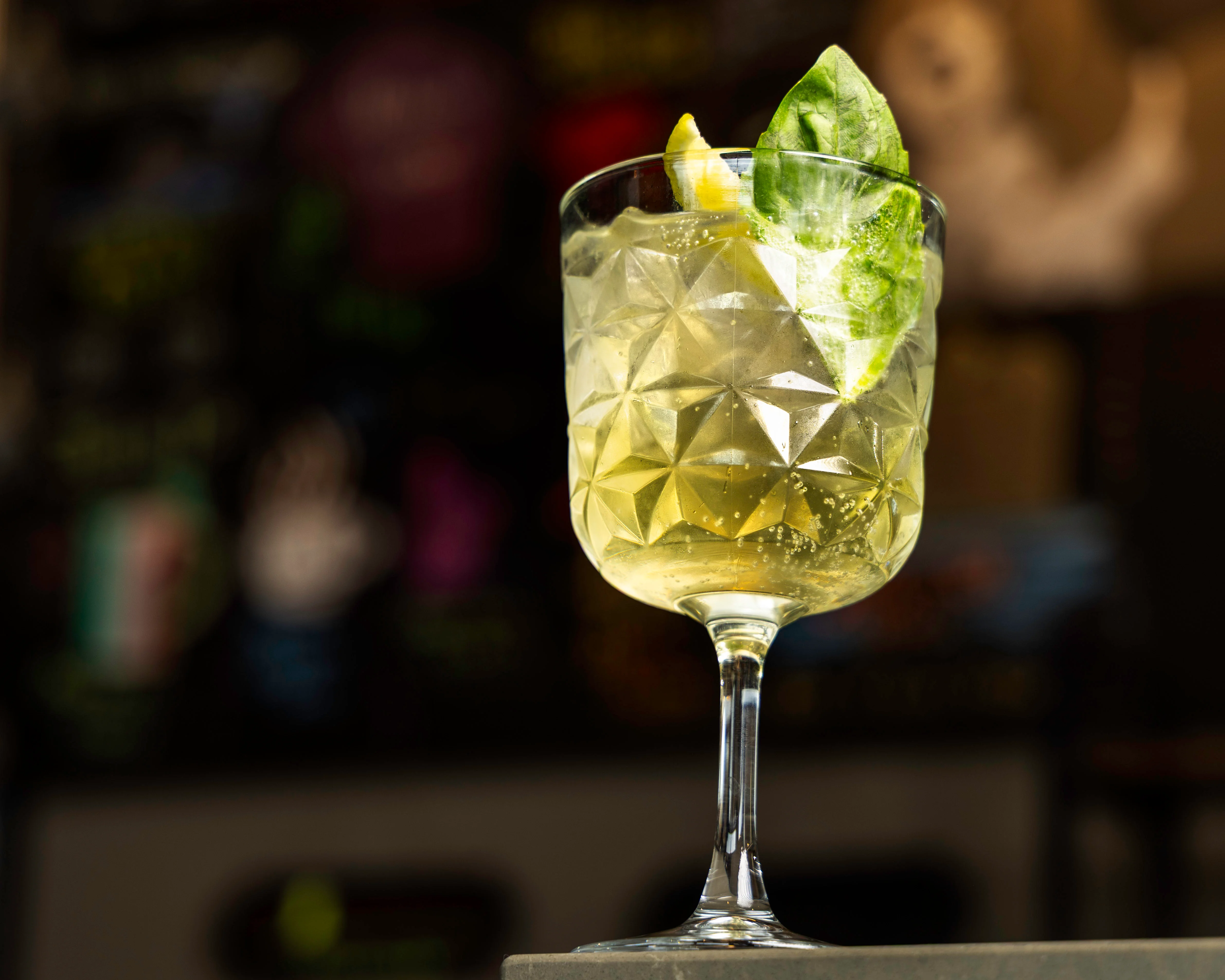A colorful dish with layered ingredients and a glass of beer.