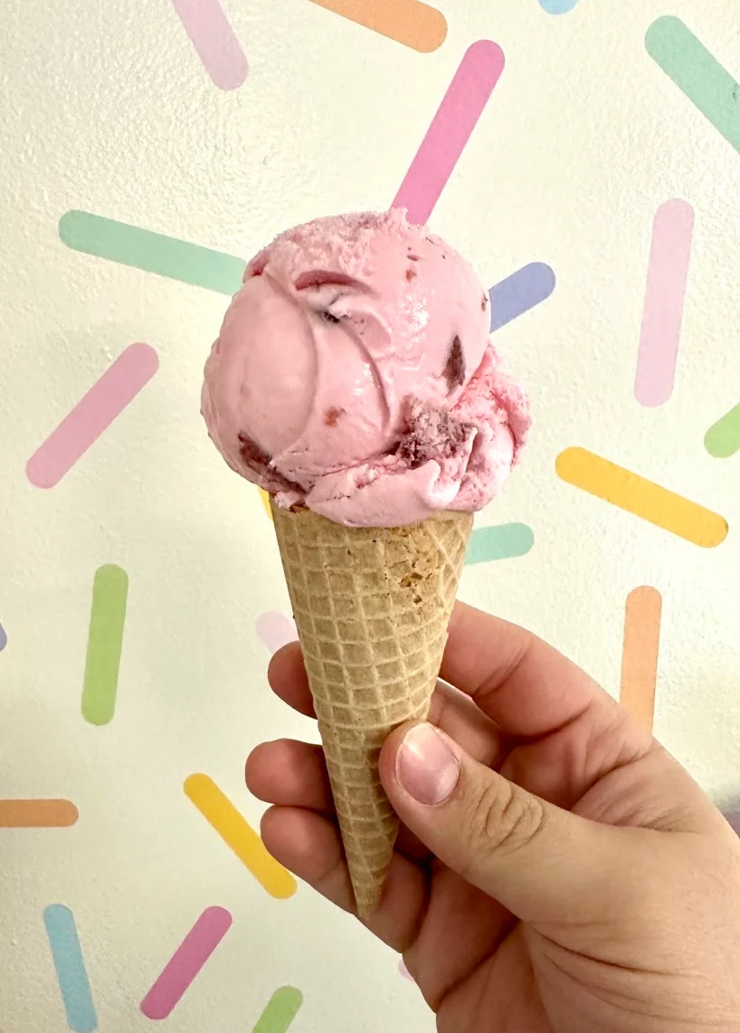 Delicious strawberry ice cream cone against a colorful backdrop