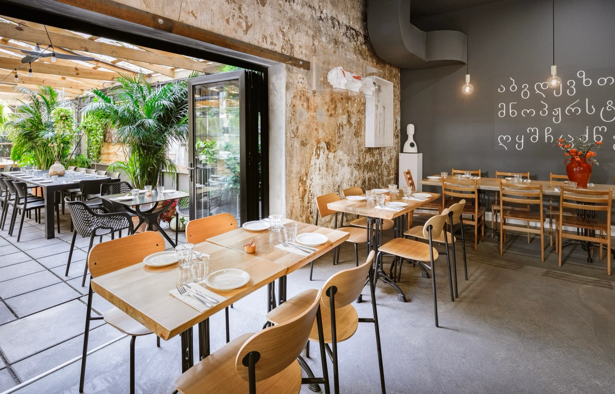 Chama Mama Chelsea dining room opening onto the covered garden