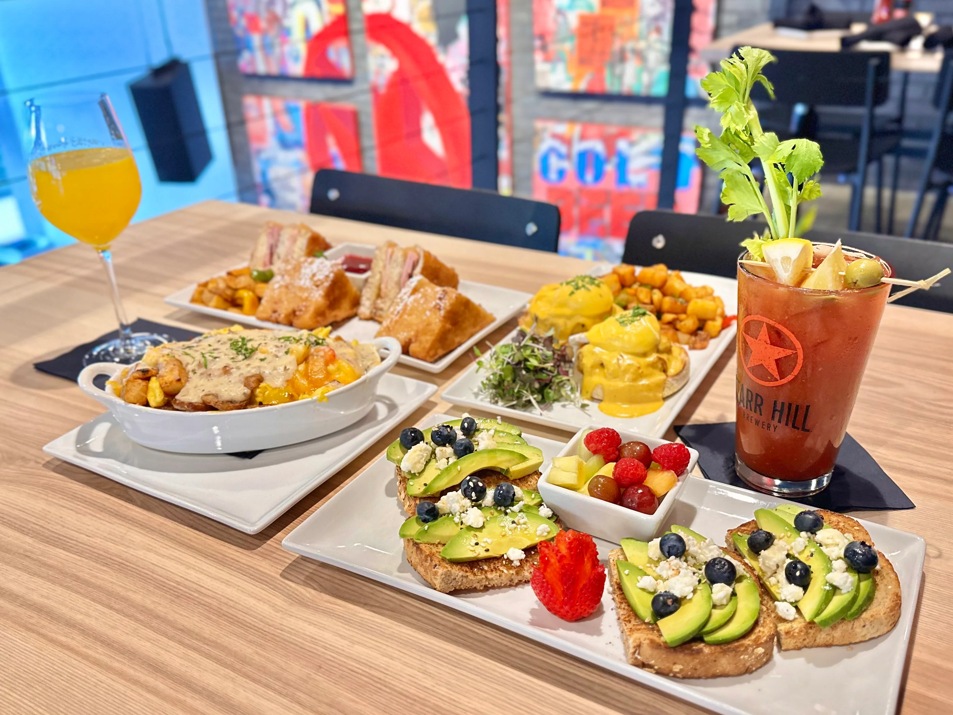 Brunch spread featuring avocado toast and eggs Benedict
