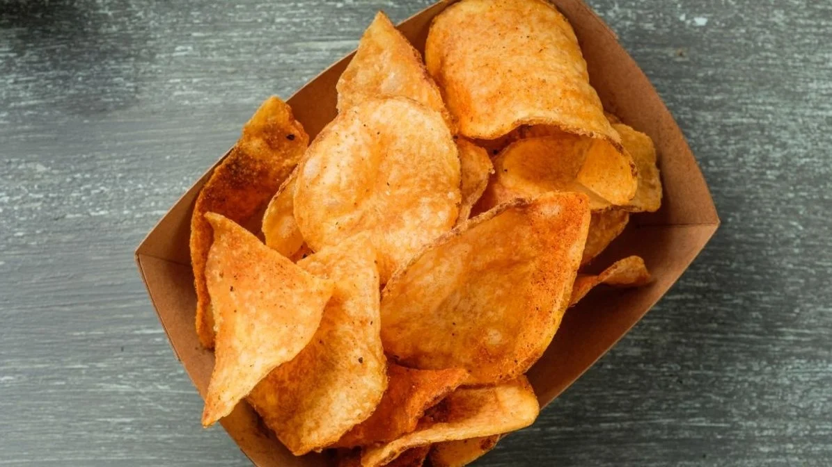 VooDoo Chips from VooDoo BBQ in Pensacola, crispy house-seasoned potato chips served as a signature side.