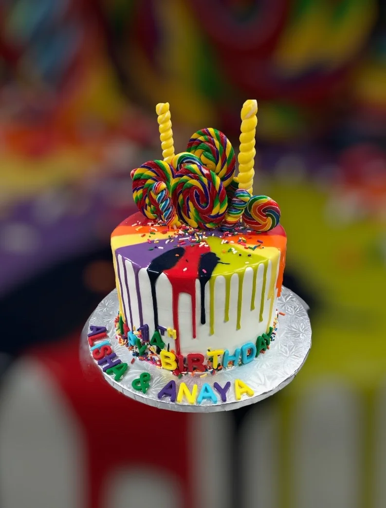 Colorful birthday cake with lollipops and candles