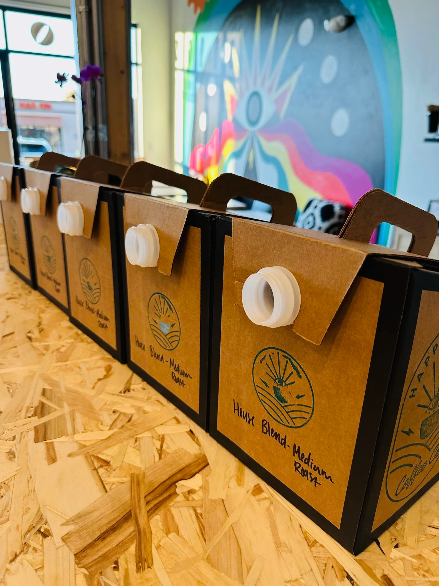 Coffee packaging with medium roast blend in a modern cafe setting