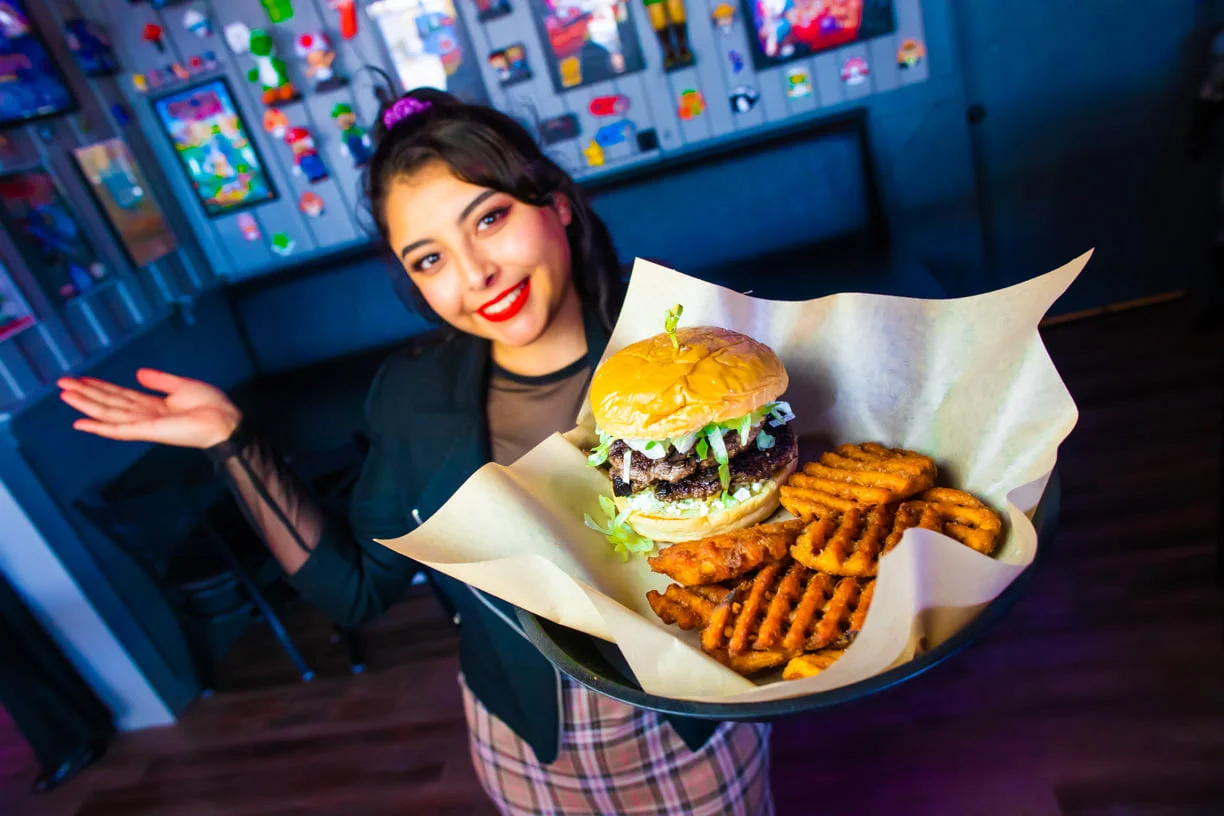 Juicy cheeseburger with waffle fries in a vibrant restaurant setting