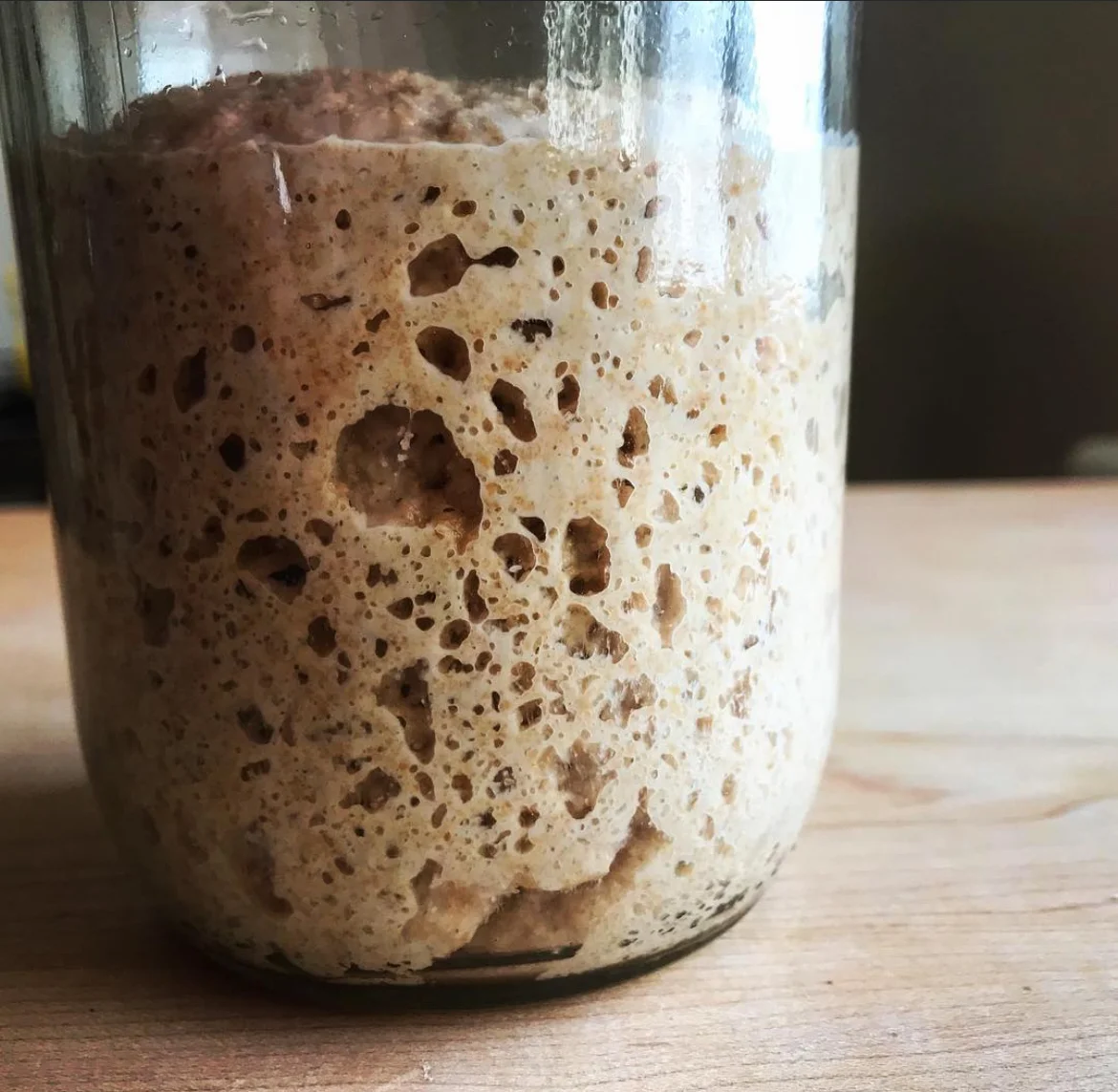 Active sourdough starter in a glass jar