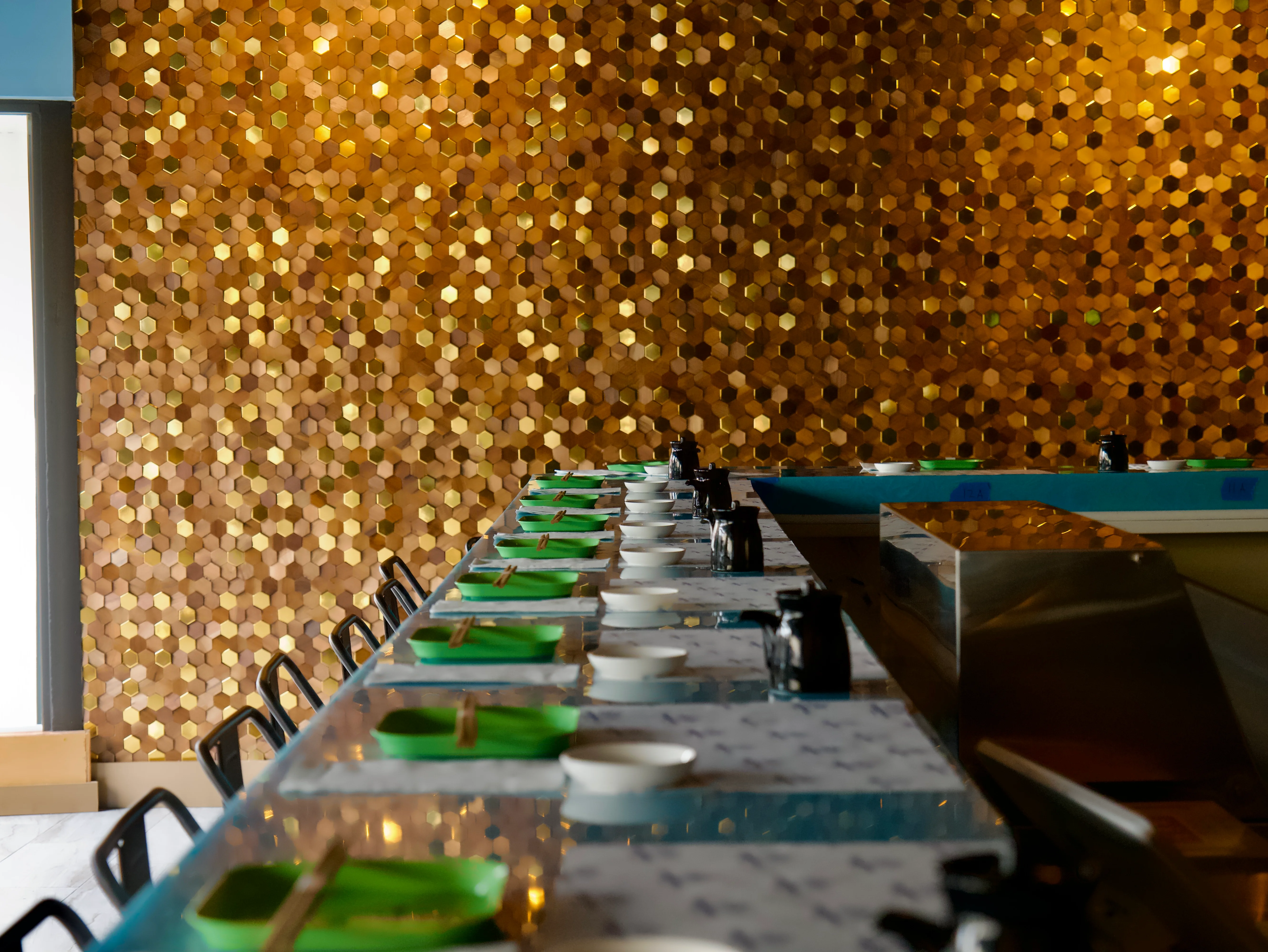 Stylish restaurant interior with hexagonal gold wall decor