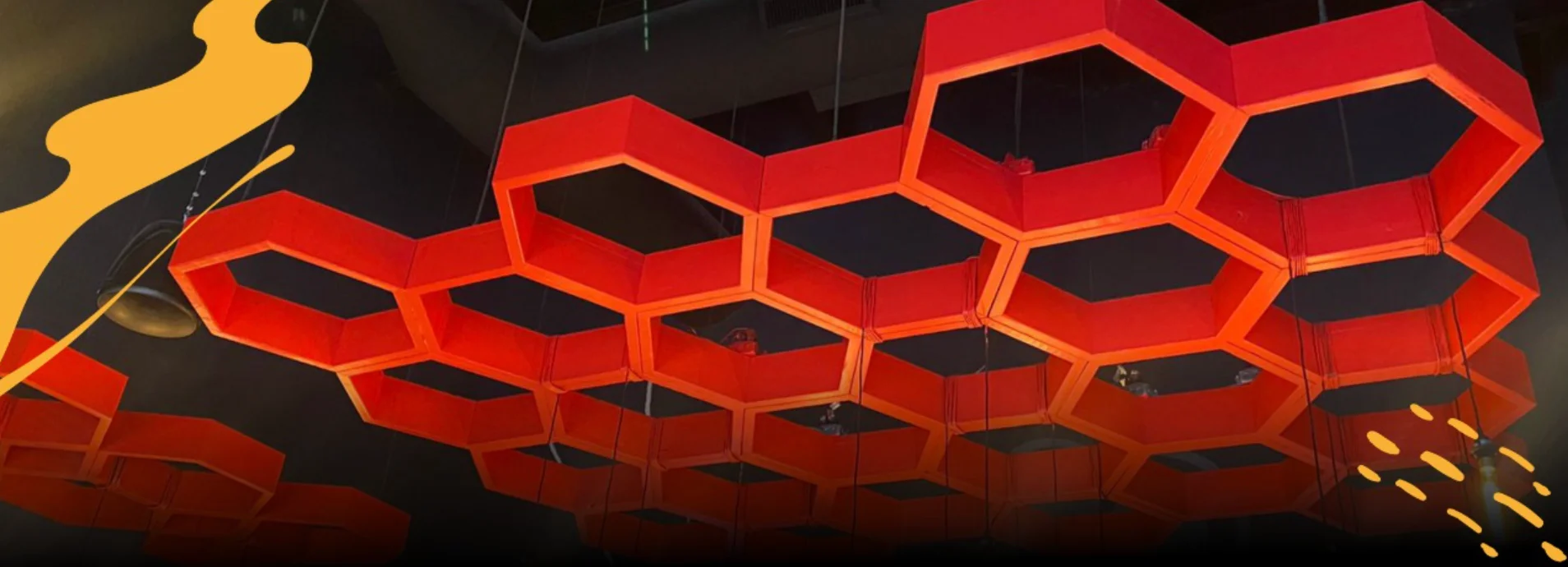 Modern restaurant ceiling with hexagonal red light fixtures