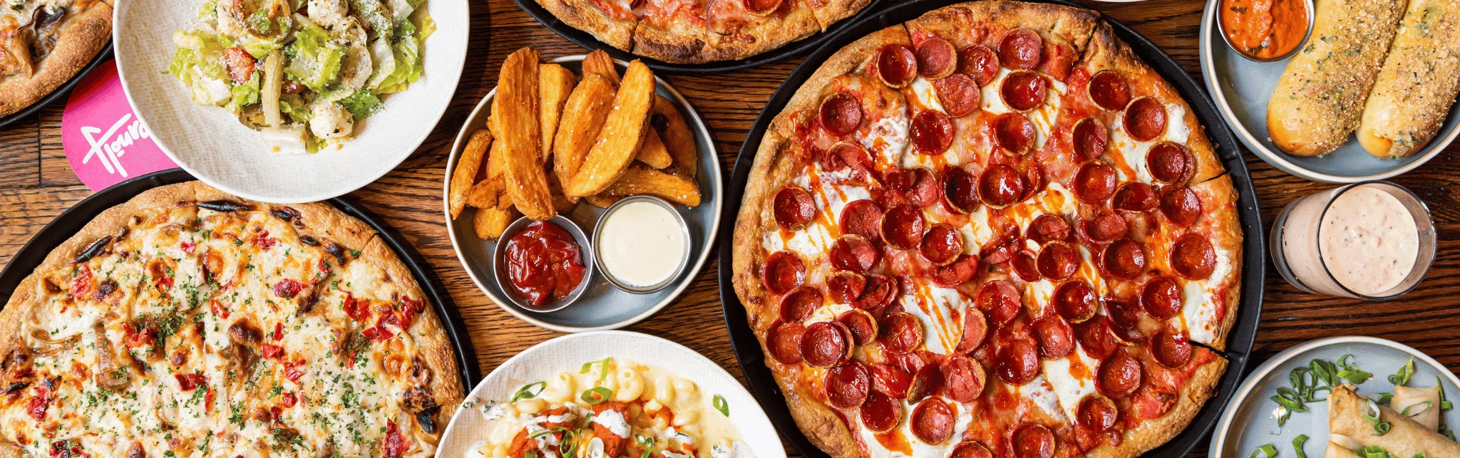Assorted pizzas and sides in a vibrant restaurant setting