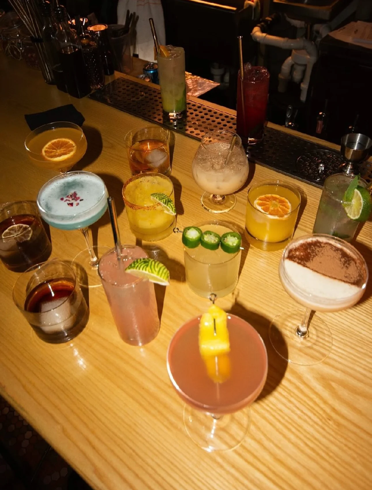 assortment of cocktails gorgeously garnished Tres Leches 
