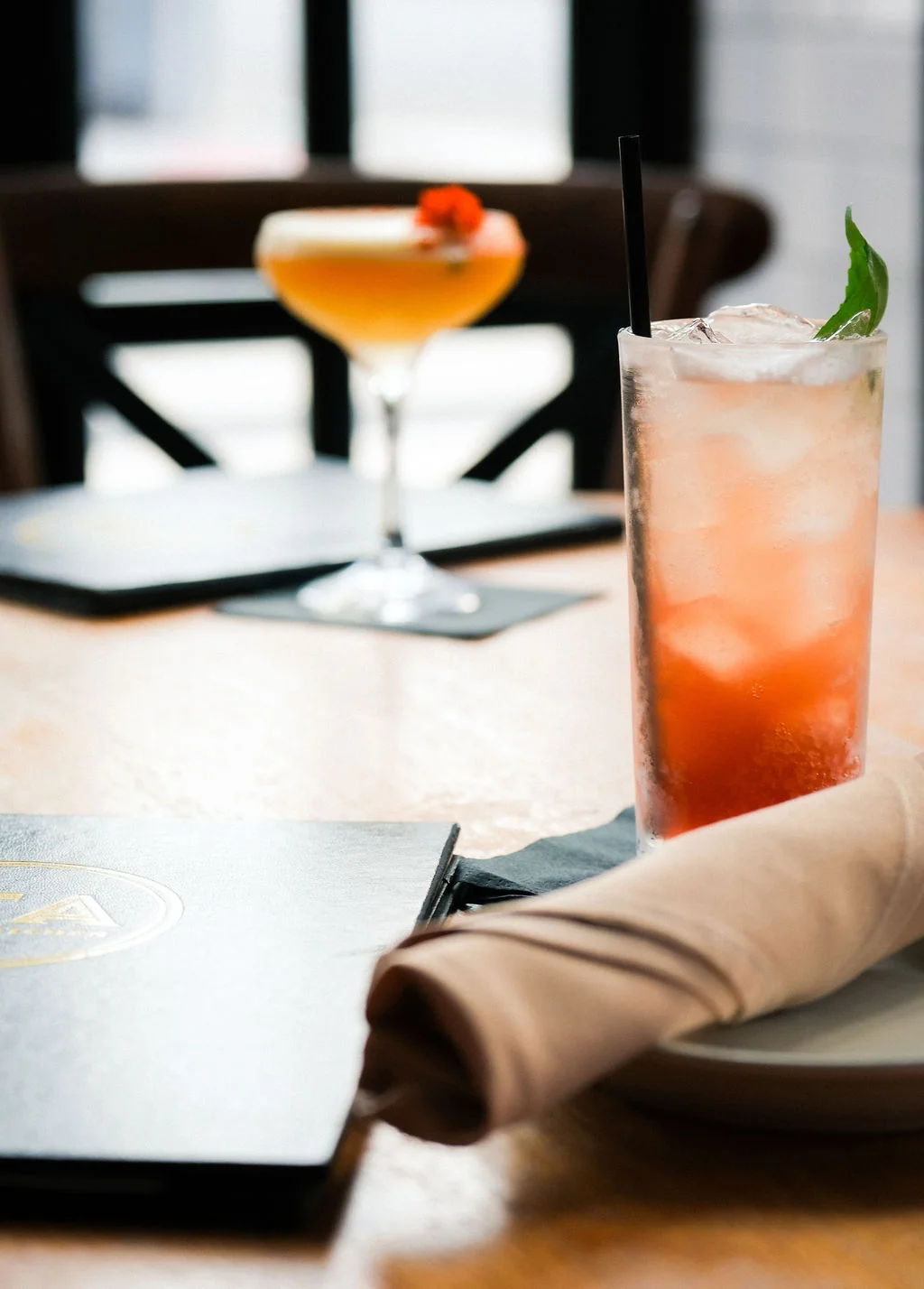 Refreshing cocktails on a wooden table in a cozy restaurant setting