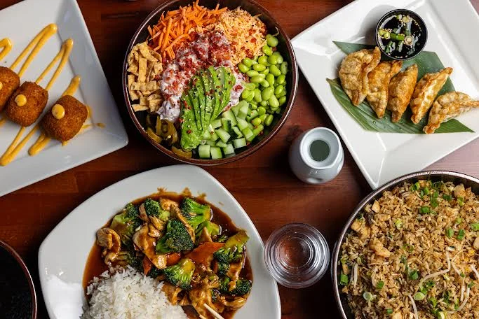 Colorful Asian-inspired rice bowl with vegetables and dumplings