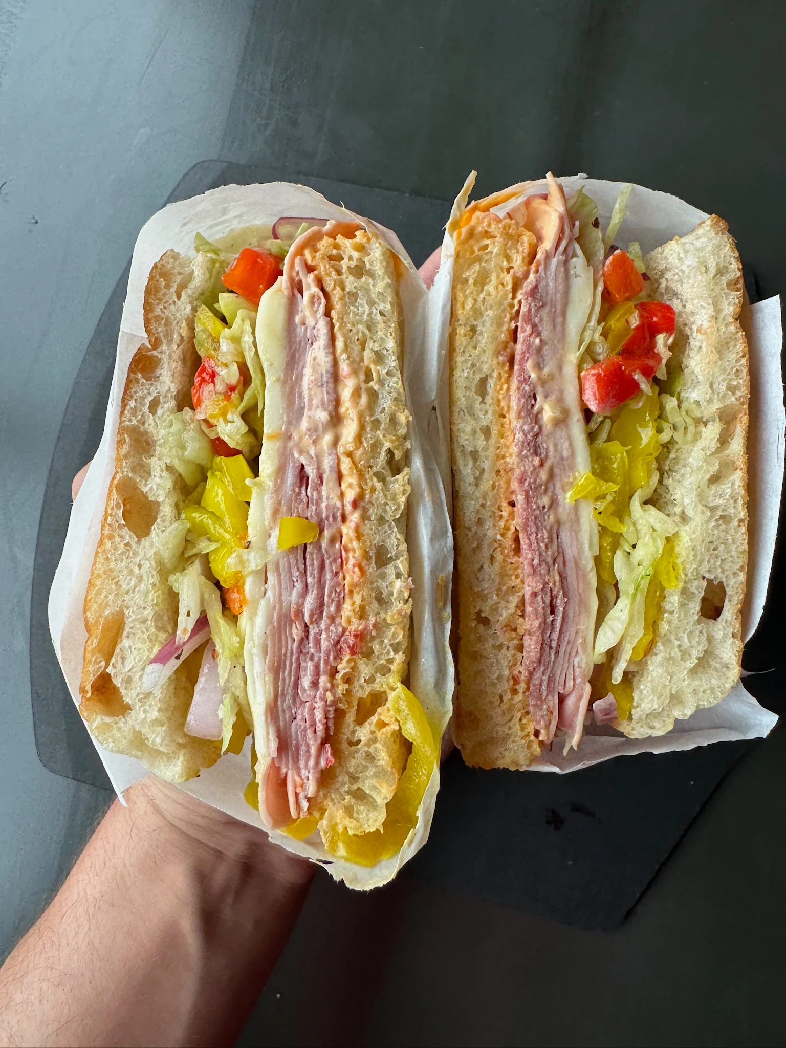Italian sub sandwich with layers of meats and fresh vegetables
