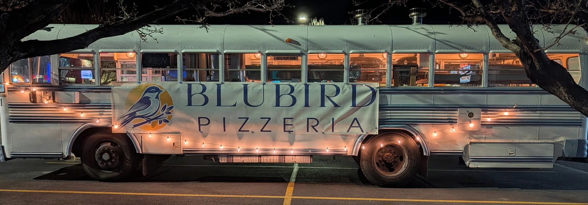 Food truck serving pizza with a cozy ambiance