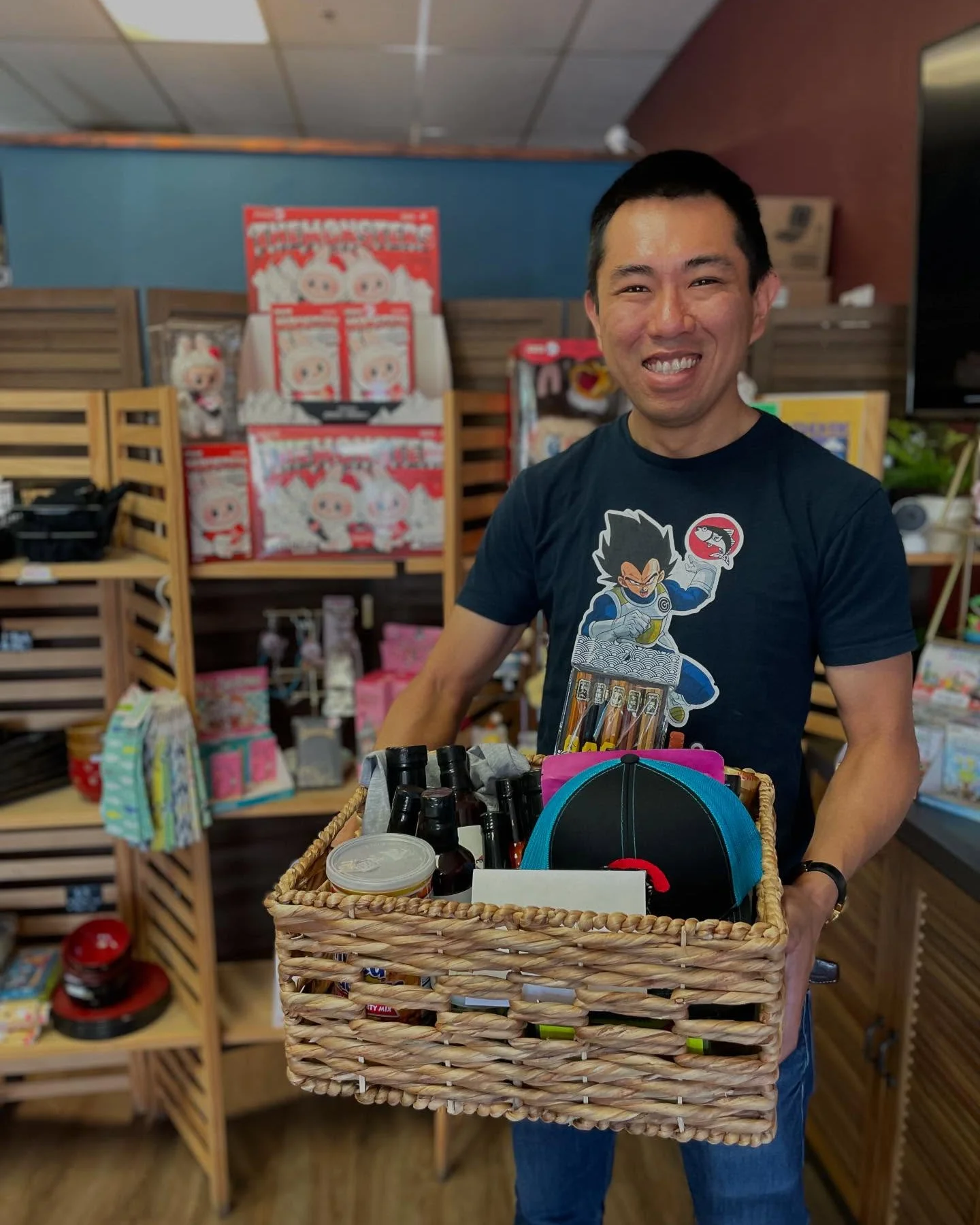 Smiling man holding a gift basket in a colorful store
