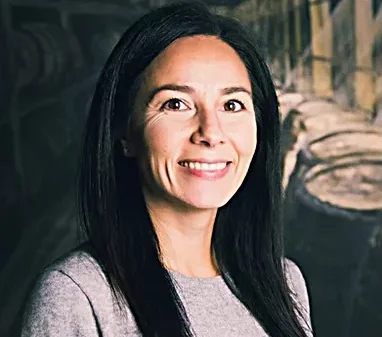 Professional woman smiling in a modern restaurant setting