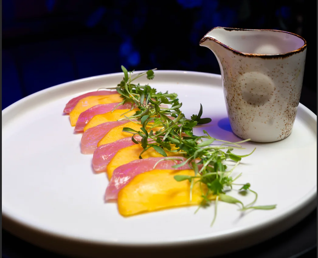 Japanese sashimi with mango and microgreens