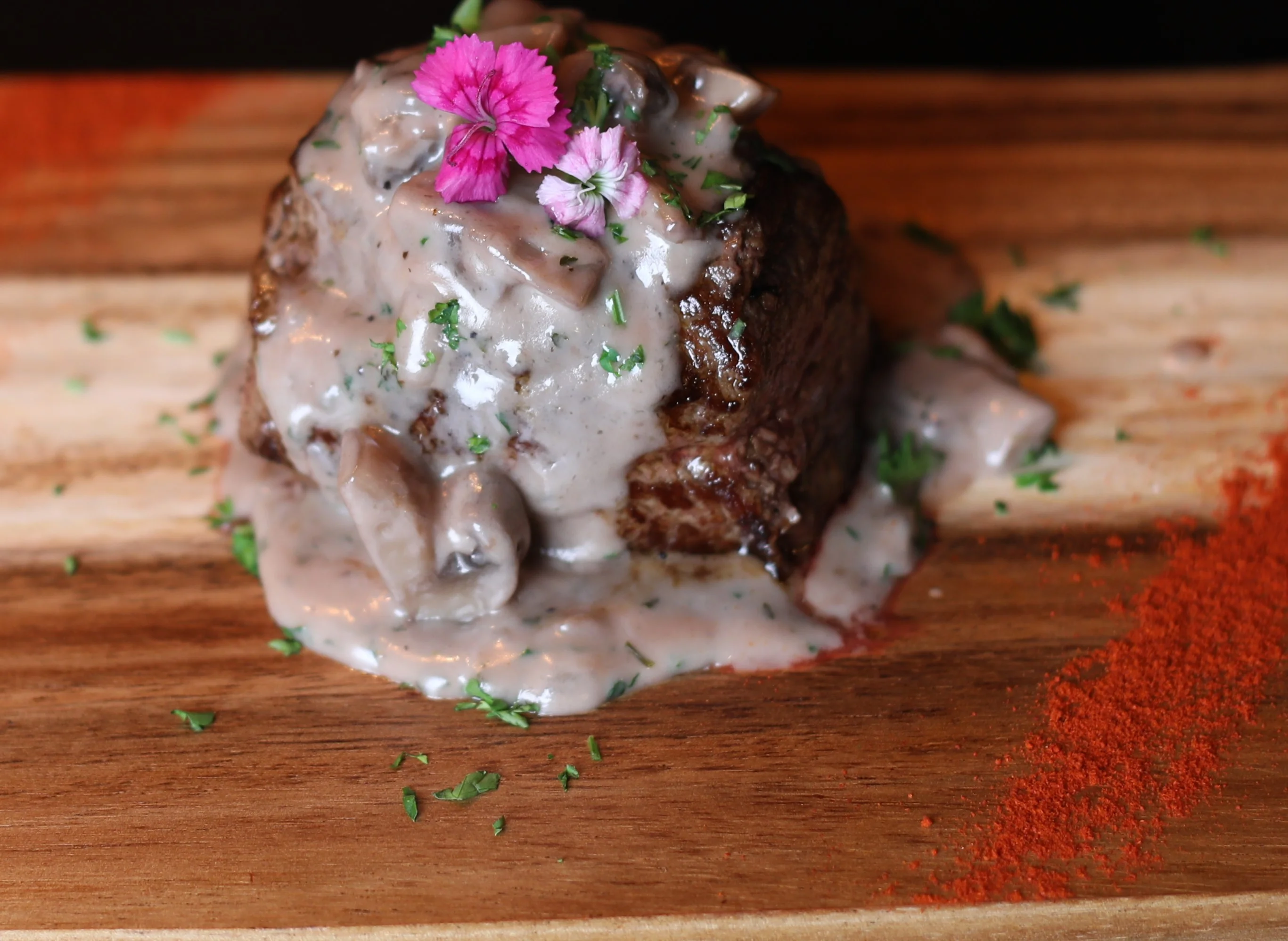 Juicy grilled beef tenderloin served on a plate with garnishes.