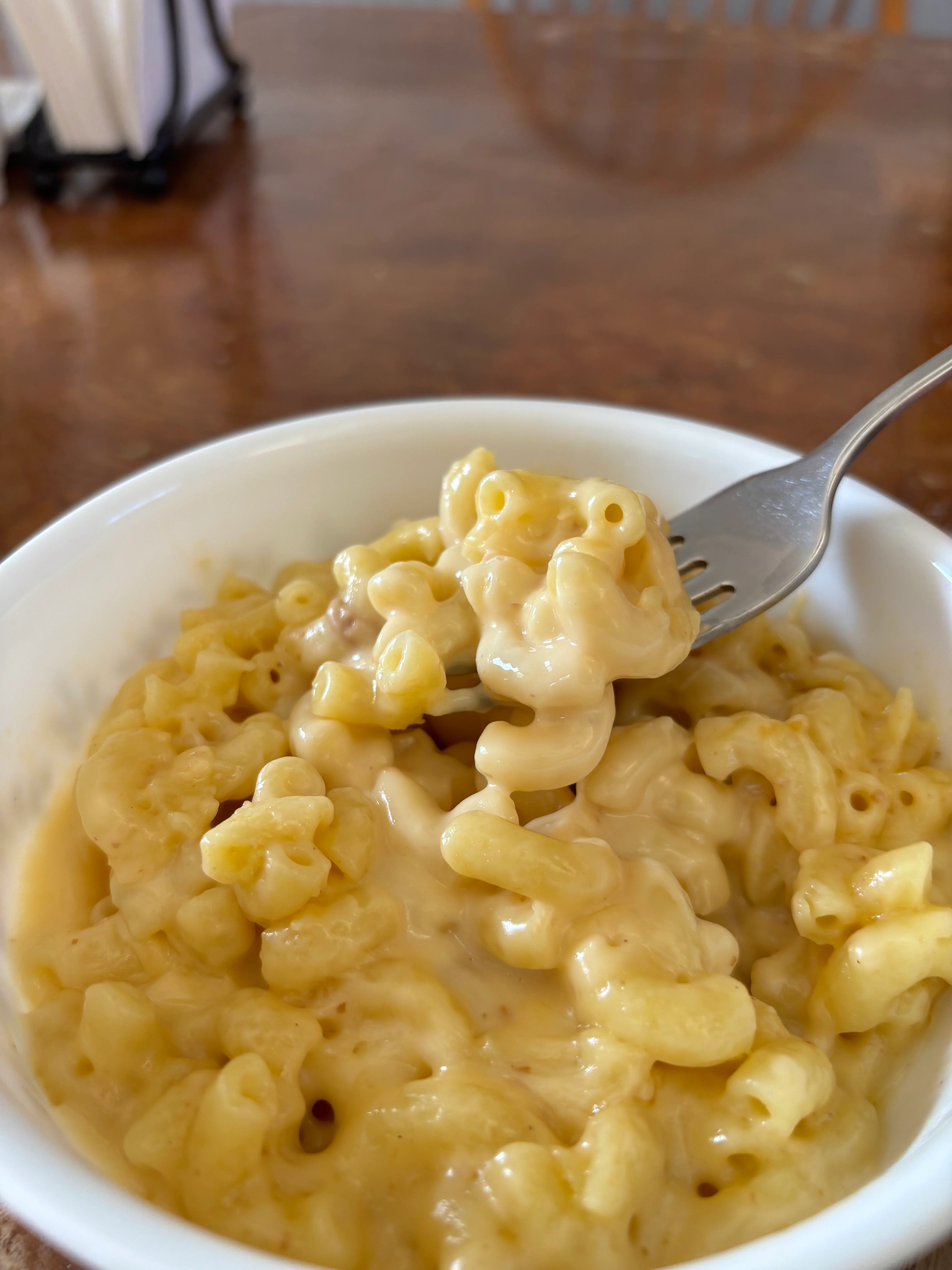 Creamy macaroni and cheese in a white bowl