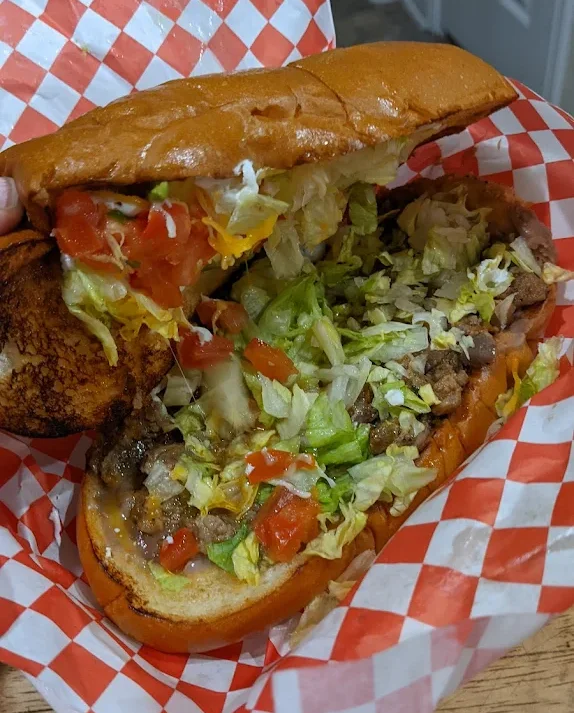 Delicious gourmet burger with fresh toppings on a wooden table