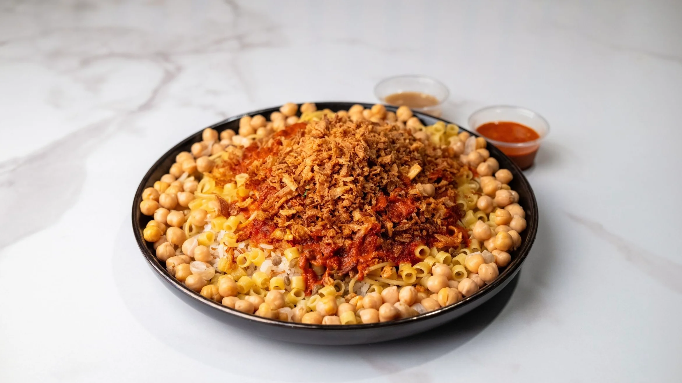 A round, golden-brown flatbread with a crispy texture, displayed against a white background.