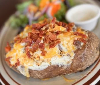 Loaded baked potato topped with cheese and bacon