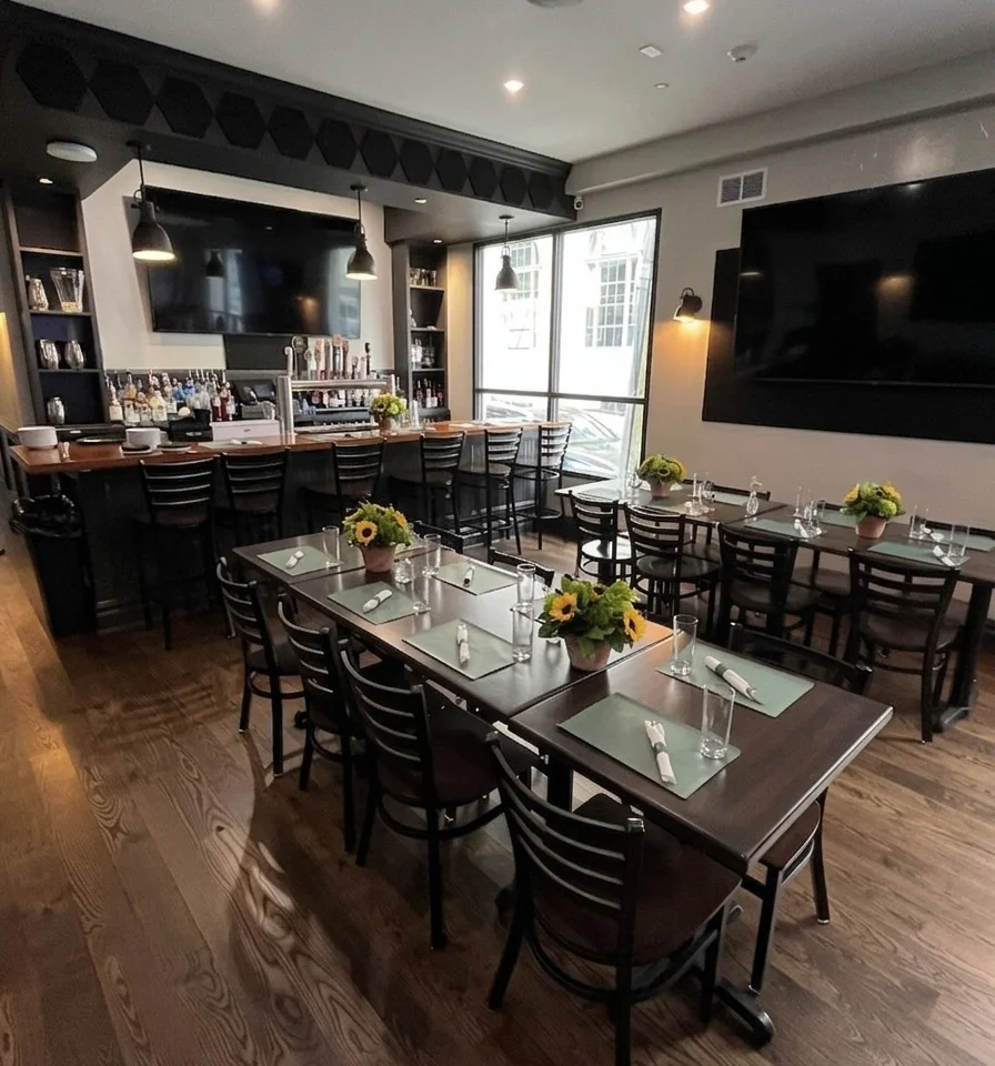Modern restaurant interior with wooden tables and bar area