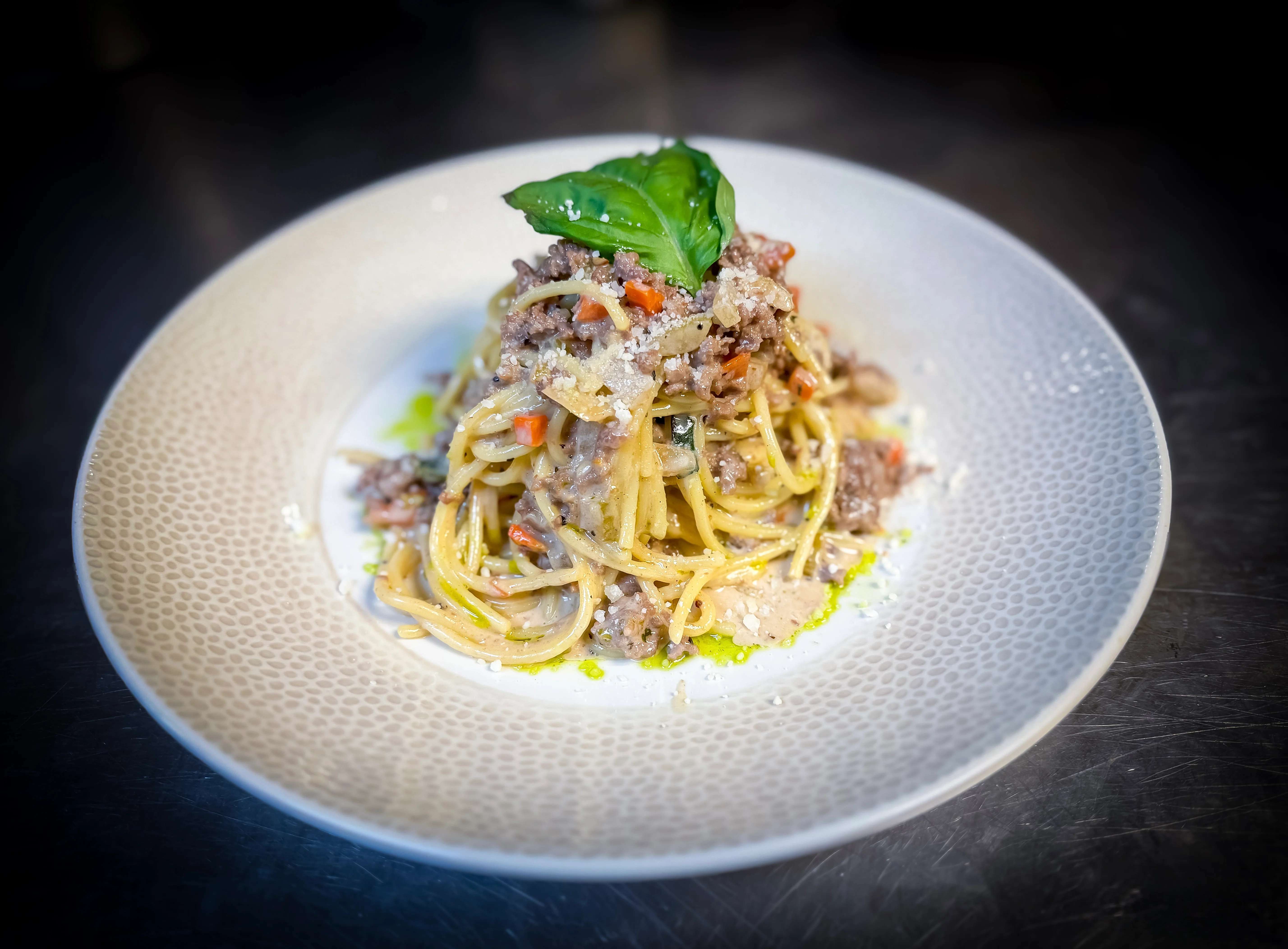 Plate of spaghetti with marinara sauce and cheese, a classic Italian dish