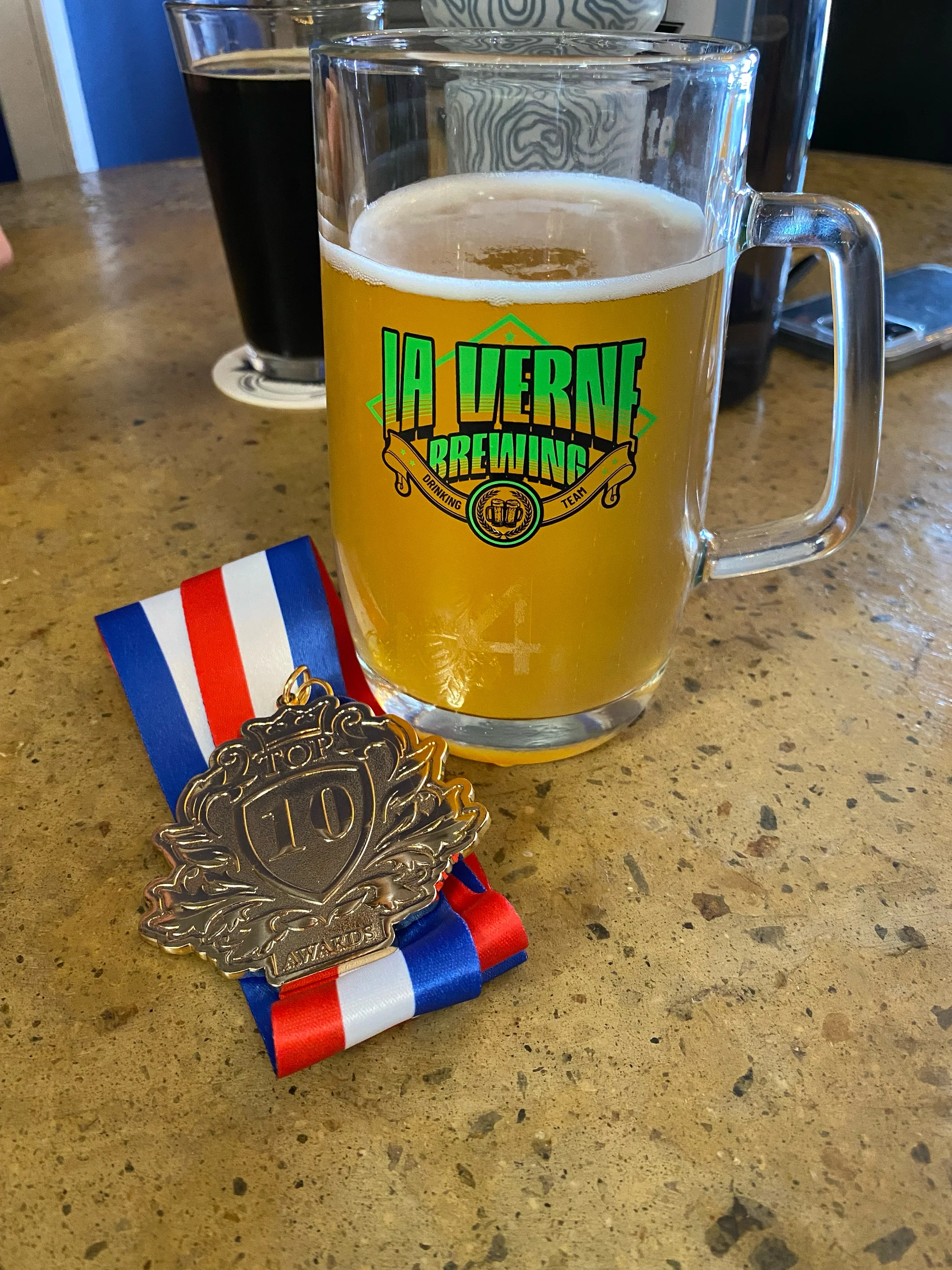 Craft beer in a glass with a medal for top 10 award