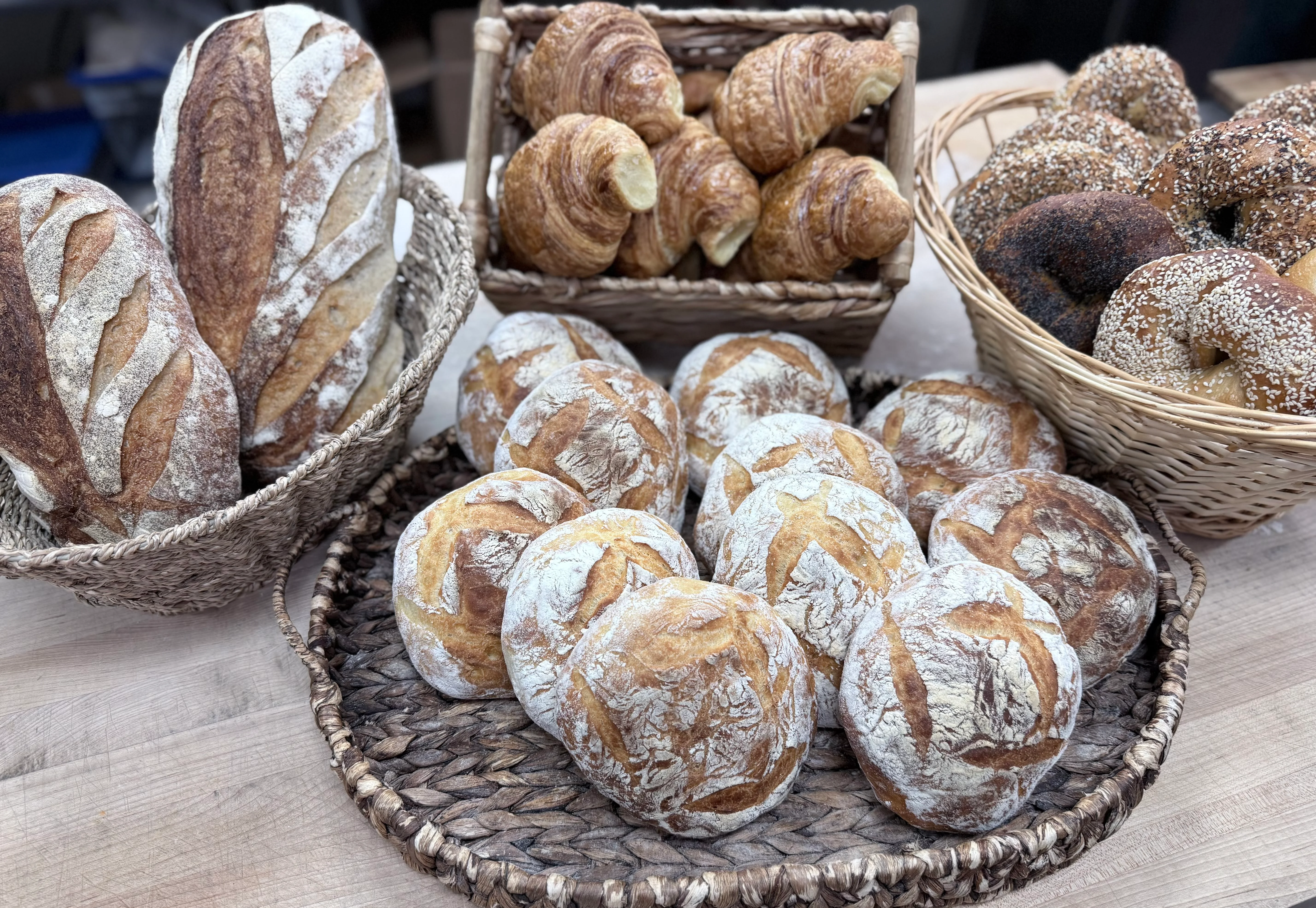 Artisan bread selection including sourdough and croissants