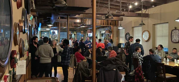 A lively restaurant scene with people socializing and dining.