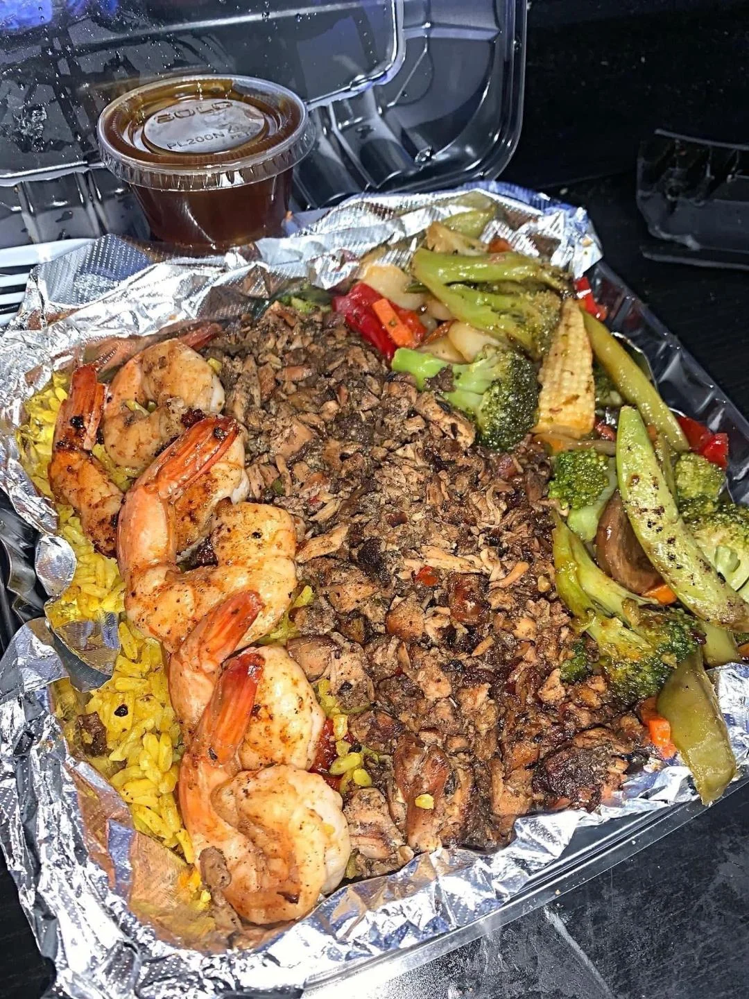 Caribbean-style shrimp and rice platter with grilled vegetables