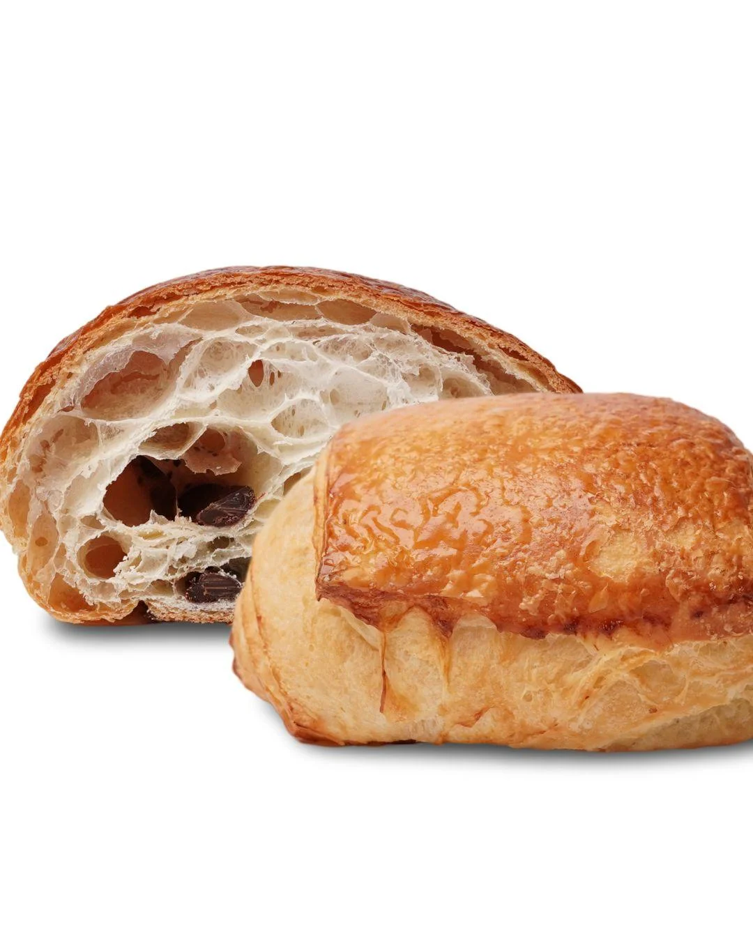 A chocolate croissant with a golden-brown crust, revealing a fluffy interior dotted with chocolate pieces.