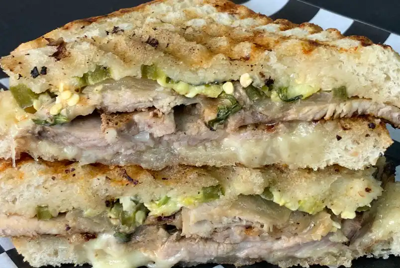 Our top seller, the Revelo sandwich has pork shoulder marinated in mojo sauce for 24 hours, then roasted and sliced with caramelized onion, picked jalapeno, fresh cilantro, roasted garlic mayo and Swiss cheese on our grilled sourdough.