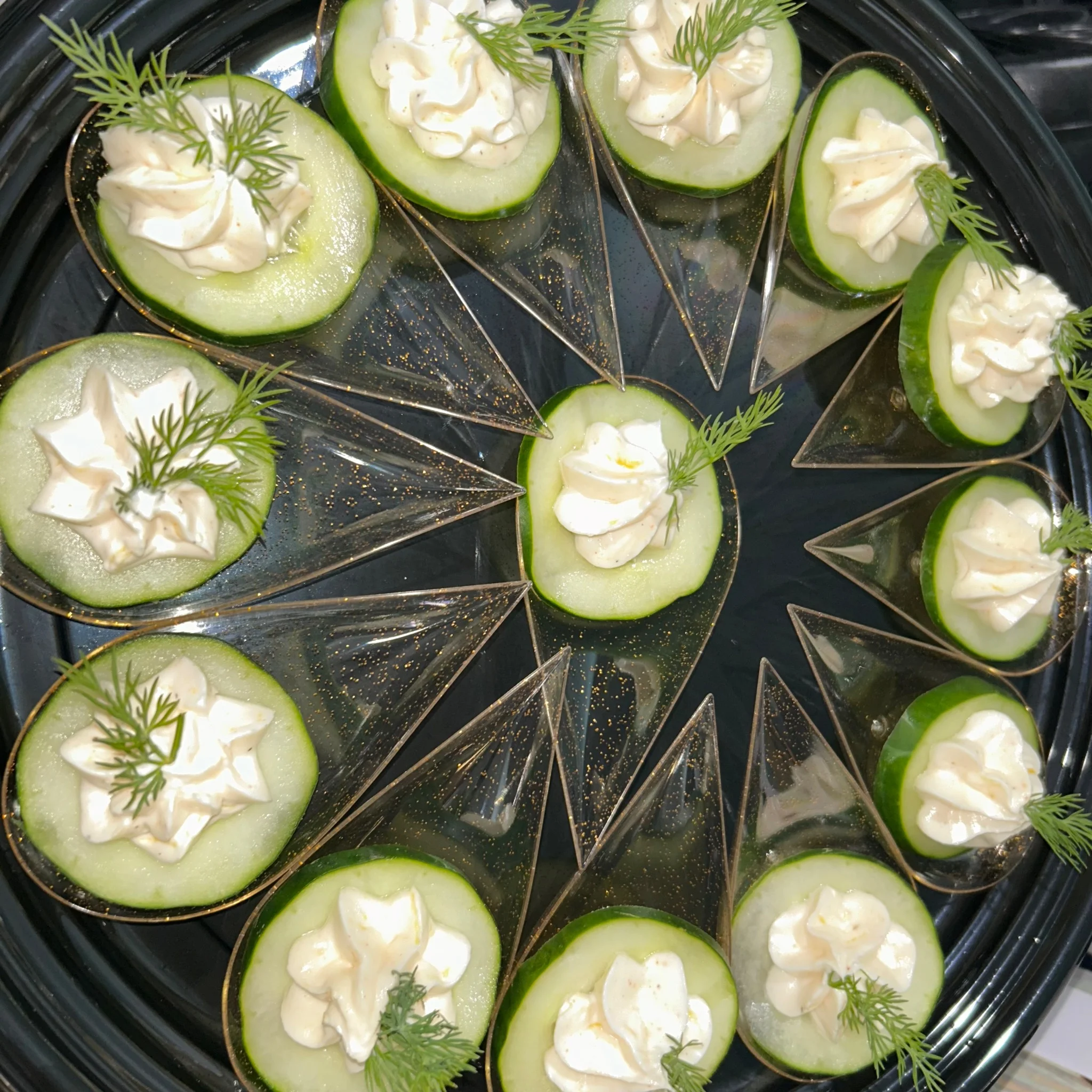 Elegant cucumber canapés with creamy topping and dill garnish