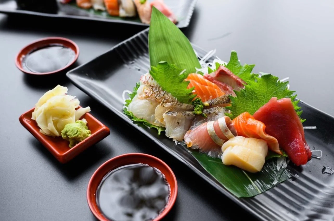 Japanese sashimi platter with assorted raw seafood and shiso leaves