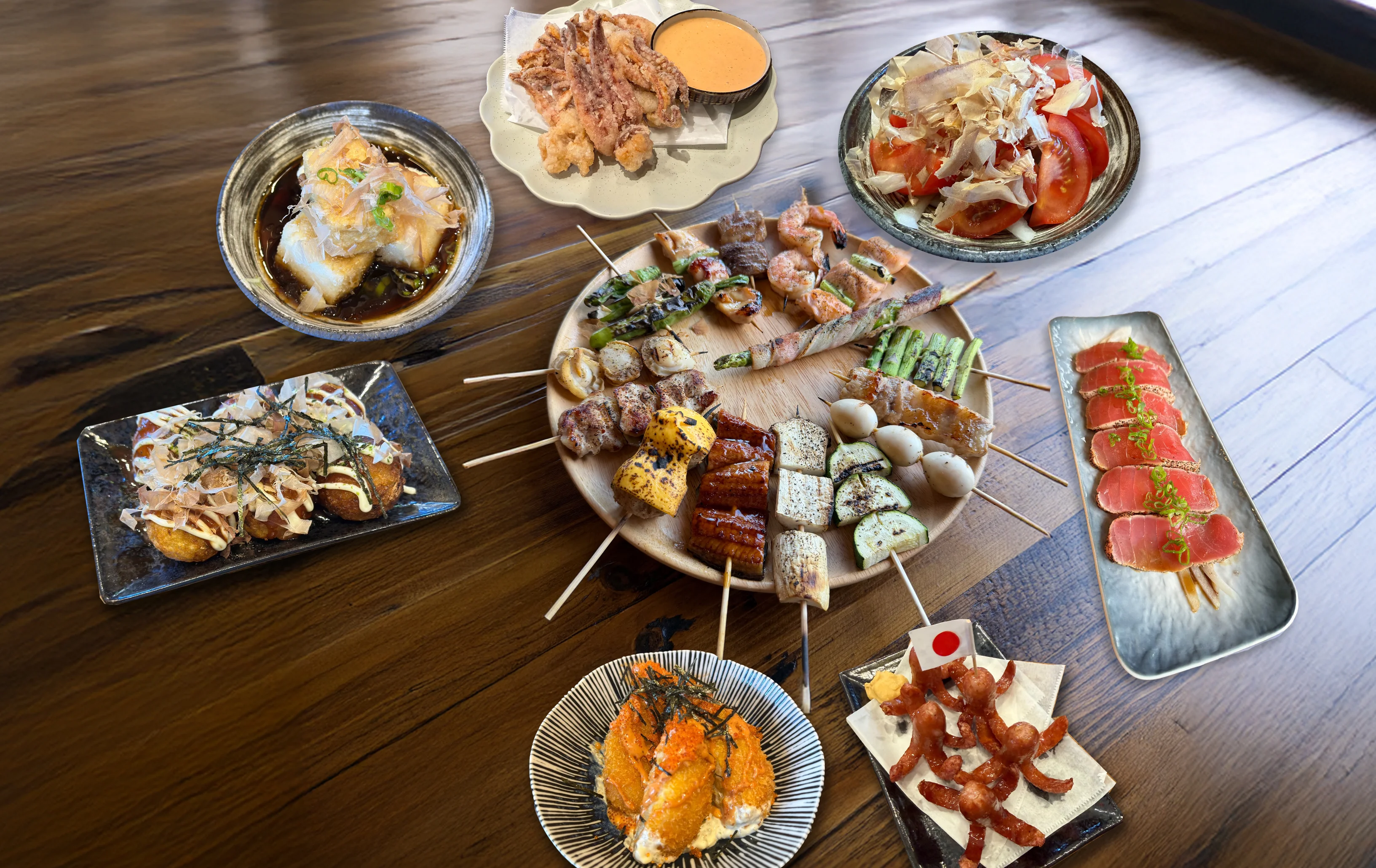 Japanese yakitori platter with assorted grilled skewers and side dishes