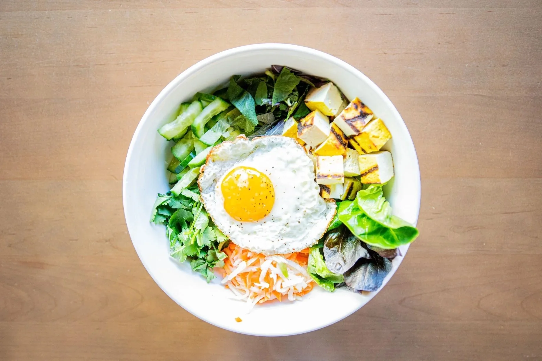 Colorful Vietnamese rice bowl with fried egg